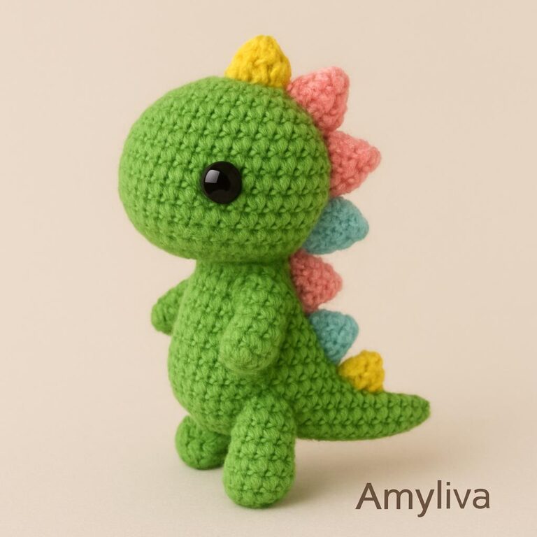 Handmade amigurumi mini dinosaur crocheted with green yarn, perfect for beginners.
