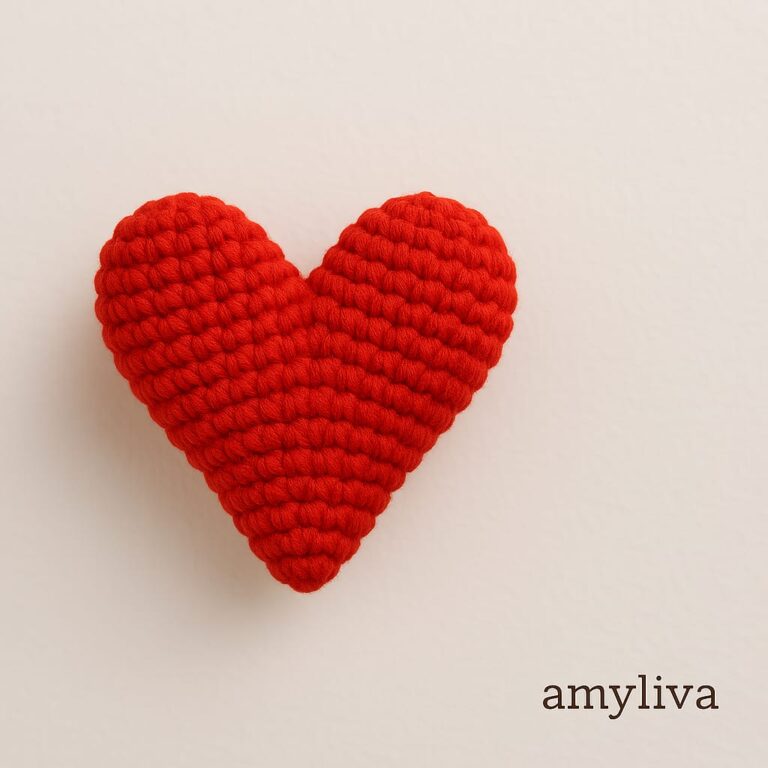 Close-up of a handmade amigurumi heart made with red yarn