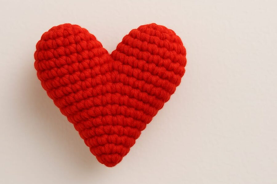 Close-up of a handmade amigurumi heart made with red yarn