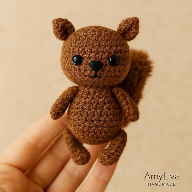Handmade Squirrel Keychain – Cute and Natural Design* This adorable squirrel figure is handcrafted with warm brown tones, giving it a natural and cozy look. Its small black eyes and delicate nose add a charming expression, while the detailed crochet work showcases the care put into its creation. *Features:* - *Material:* Cotton crochet yarn - *Details:* Secure eyes, fine embroidery work - *Usage:* Easily attachable to bags or keys with a keychain ring - *Brand:* Labeled "AmyLiva HANDMADE" as an original design Would you like to add a handmade squirrel like this to your collection? 🌿🐿