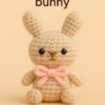 Handmade mini amigurumi bunny with a pink bow – front view
