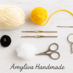Crochet tools and yarn arranged for a handmade keychain project.